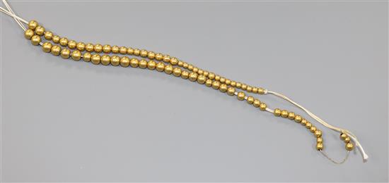 A yellow metal bead necklace (a.f.).